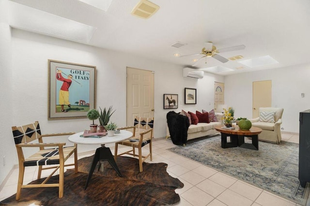 living room featuring ceiling fan, light tile patterned flooring, an AC wall unit, and a skylight