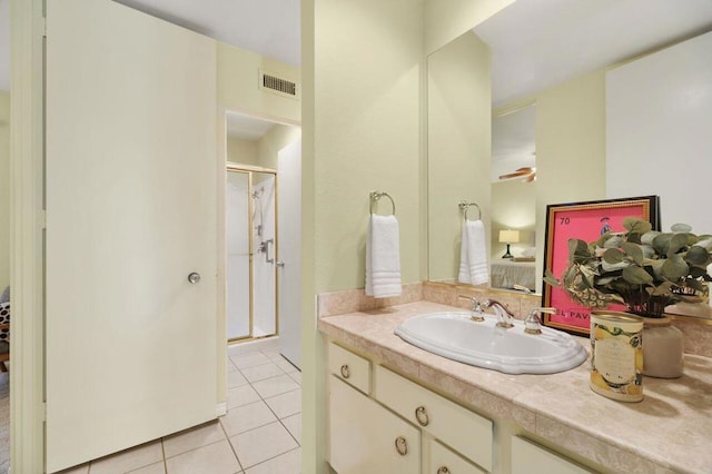 bathroom featuring tile patterned floors, vanity, and walk in shower