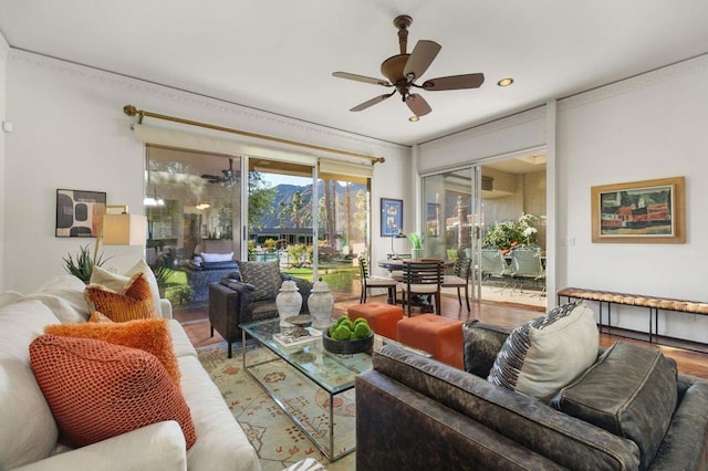 living room with ceiling fan, hardwood / wood-style flooring, and crown molding