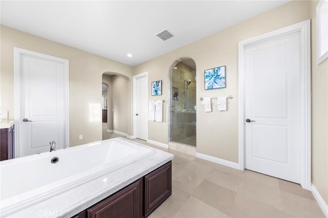 bathroom with shower with separate bathtub, vanity, and tile patterned floors