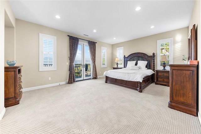 bedroom with access to exterior and light carpet