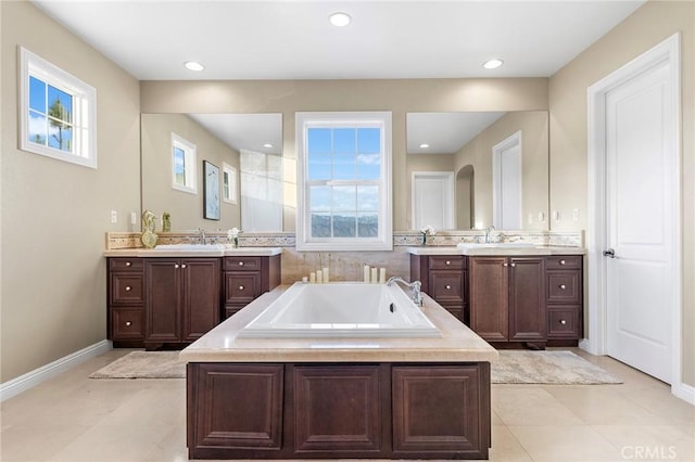 bathroom with vanity, tile patterned floors, and a tub