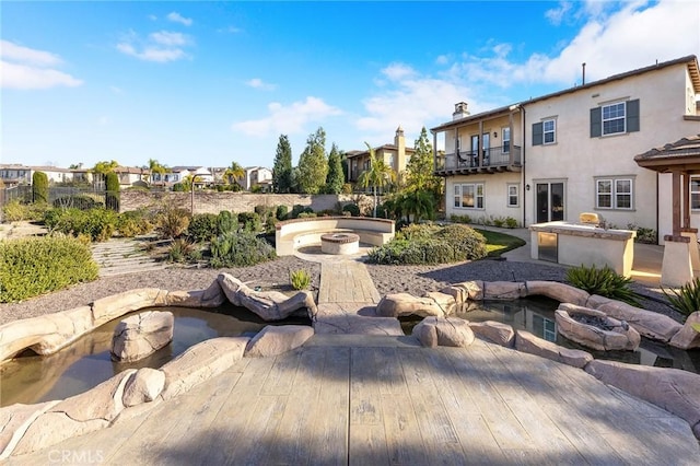 surrounding community featuring an outdoor fire pit