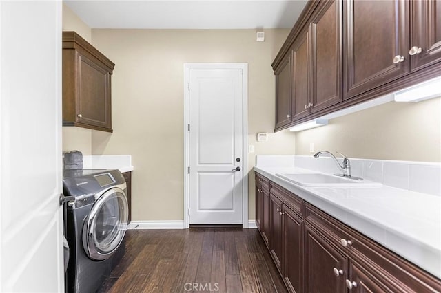 laundry area with sink, washer / clothes dryer, cabinets, and dark hardwood / wood-style floors