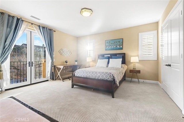 bedroom featuring french doors, light carpet, and access to exterior