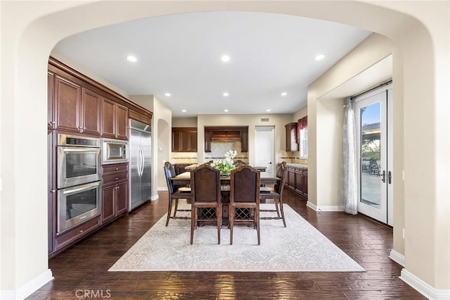 dining area featuring dark wood-type flooring