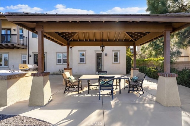 view of patio featuring sink, a gazebo, exterior kitchen, and a grill