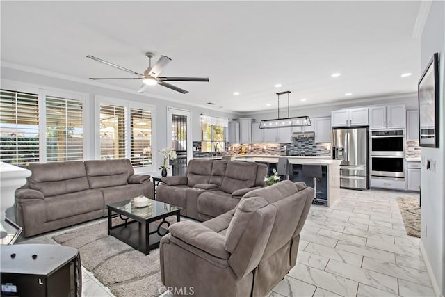 living room featuring ceiling fan and crown molding