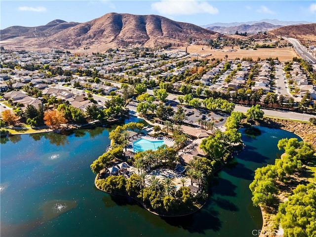 birds eye view of property with a water and mountain view