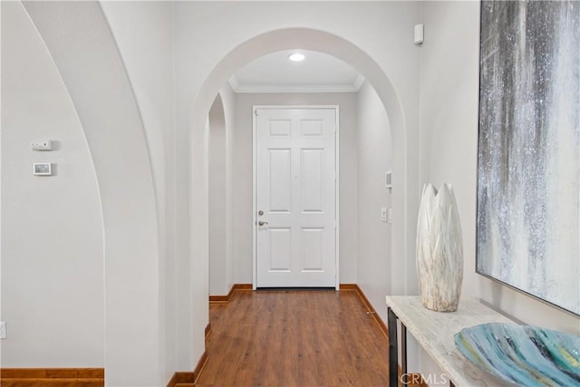 hall with ornamental molding and hardwood / wood-style floors