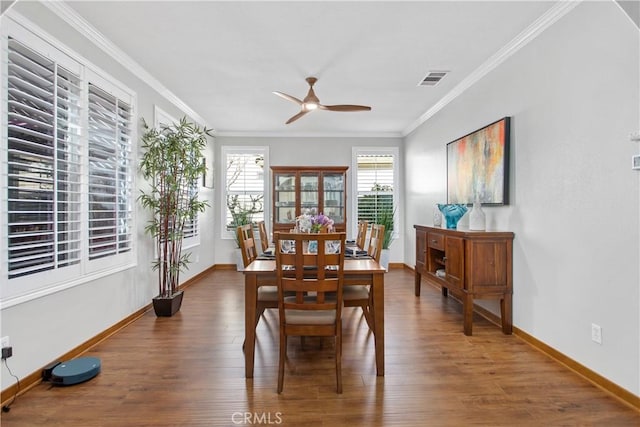 dining area featuring ornamental molding, ceiling fan, and dark wood-type flooring