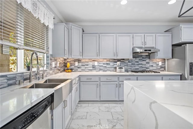 kitchen featuring sink, light stone counters, decorative backsplash, crown molding, and appliances with stainless steel finishes