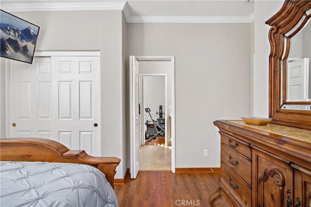 bedroom featuring a closet, crown molding, and dark hardwood / wood-style floors