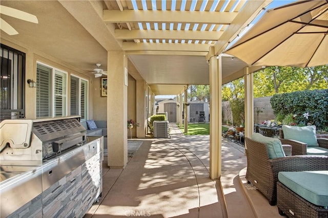 view of patio / terrace featuring exterior kitchen, ceiling fan, central AC unit, and a storage shed