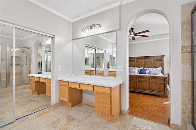 bathroom with ceiling fan, walk in shower, crown molding, and vanity