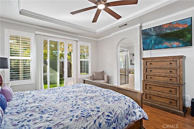 bedroom featuring ceiling fan, access to outside, ornamental molding, and a tray ceiling