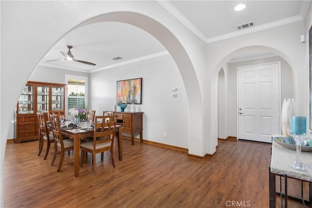 dining area with ceiling fan, ornamental molding, and dark hardwood / wood-style floors