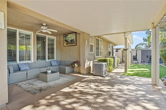 view of patio / terrace featuring a storage shed, ceiling fan, cooling unit, and an outdoor living space