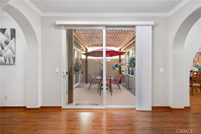 doorway to outside featuring ornamental molding and hardwood / wood-style floors