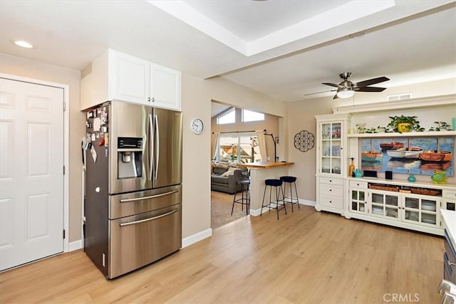 kitchen with ceiling fan, light hardwood / wood-style flooring, white cabinetry, and stainless steel refrigerator with ice dispenser