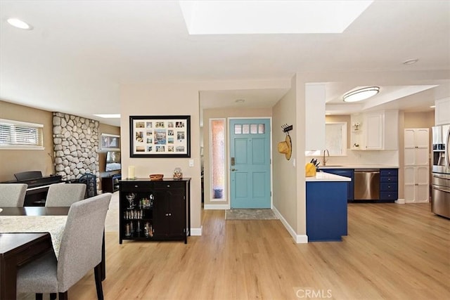 dining space featuring sink and light hardwood / wood-style flooring