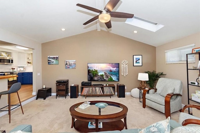 carpeted living room featuring ceiling fan and lofted ceiling