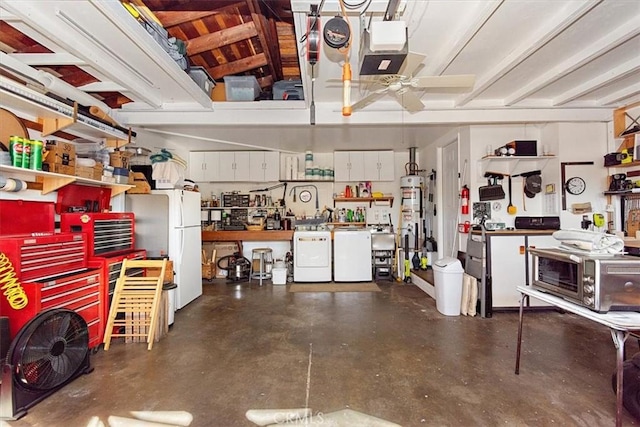 garage with separate washer and dryer, white fridge, a workshop area, secured water heater, and ceiling fan