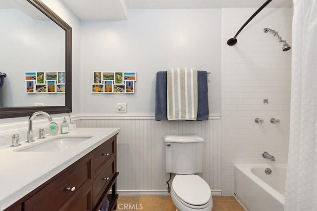 full bathroom featuring toilet, shower / bath combo with shower curtain, tile patterned floors, and vanity