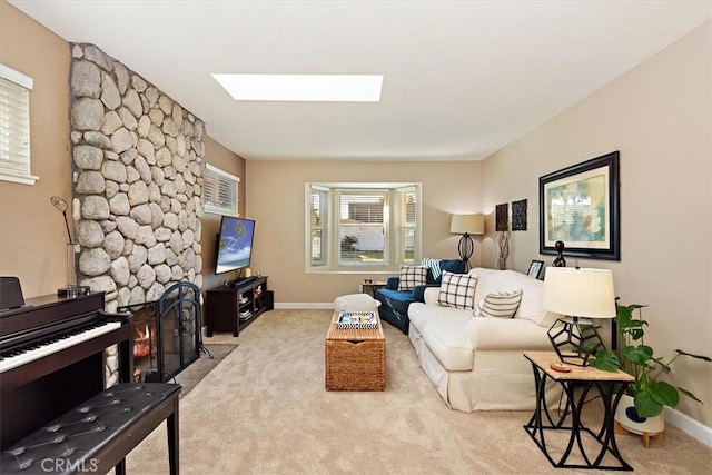 carpeted living room with a skylight