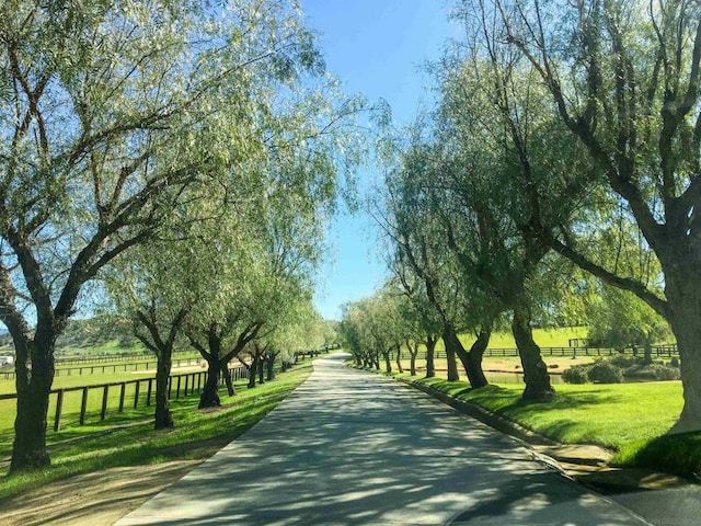 view of home's community featuring a rural view and a lawn