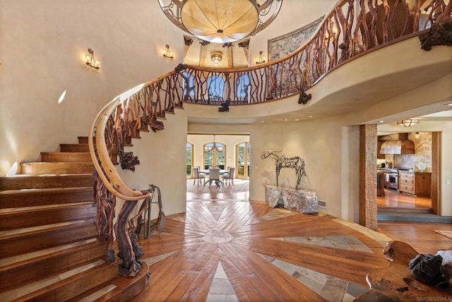 interior space with a notable chandelier and a towering ceiling