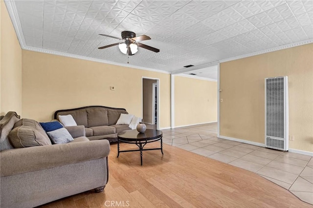 living room with ornamental molding, wood-type flooring, and ceiling fan