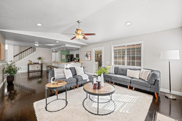 living room featuring ceiling fan, lofted ceiling, and dark hardwood / wood-style floors