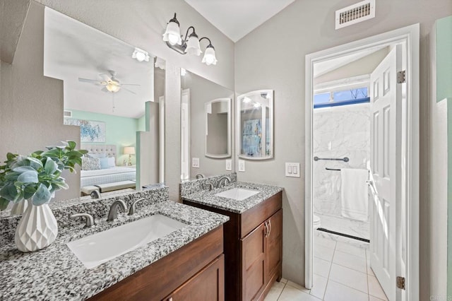 bathroom with tile patterned flooring, vaulted ceiling, toilet, vanity, and ceiling fan