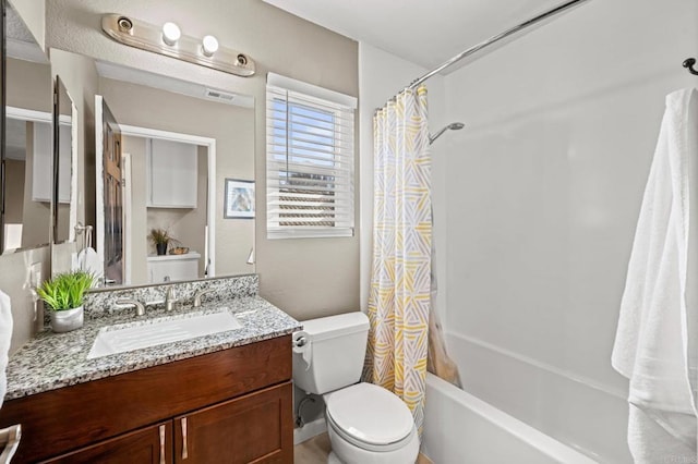 full bathroom featuring toilet, shower / tub combo with curtain, and vanity