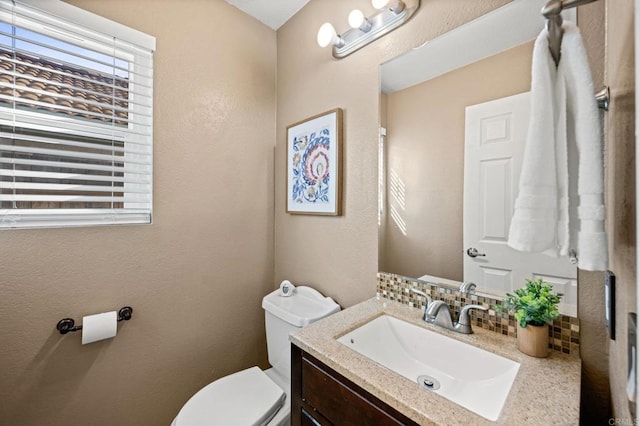 bathroom featuring toilet and vanity