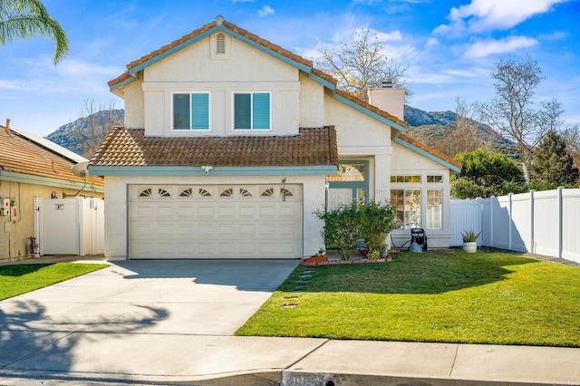 view of property featuring a garage, a front lawn, and a mountain view