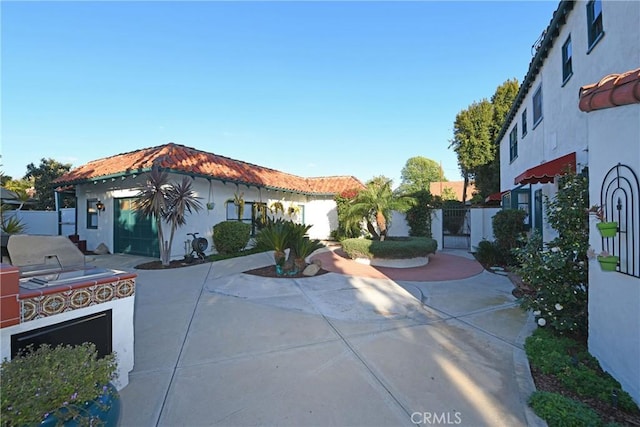 view of front of property featuring exterior kitchen and a patio area