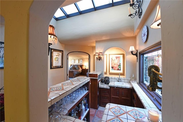 ensuite bathroom with vanity, tile patterned flooring, and connected bathroom
