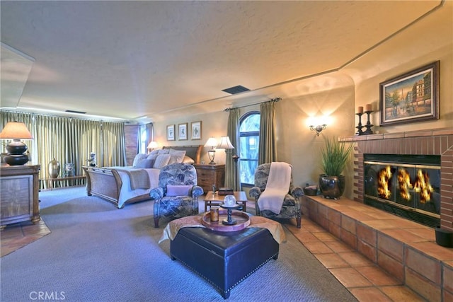 carpeted living room featuring tile patterned floors, a brick fireplace, and visible vents