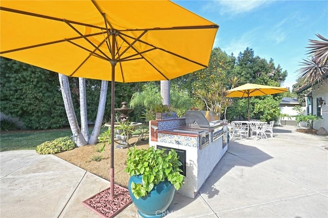 view of patio with area for grilling and an outdoor kitchen