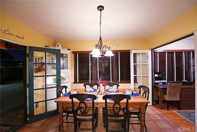 dining area featuring an inviting chandelier and tile patterned floors