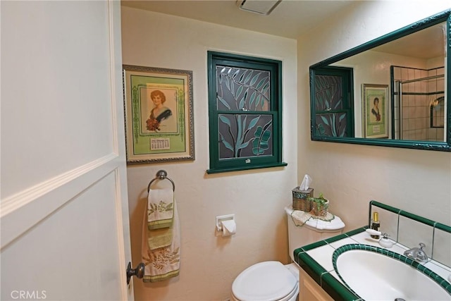 bathroom featuring toilet and vanity