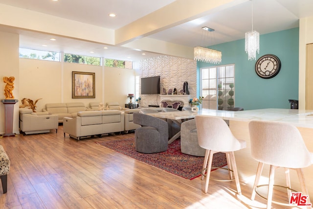 living room featuring an inviting chandelier and light hardwood / wood-style floors