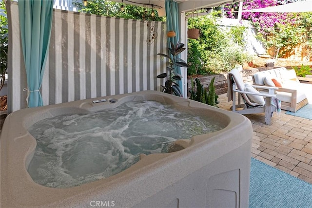 view of patio / terrace with a hot tub