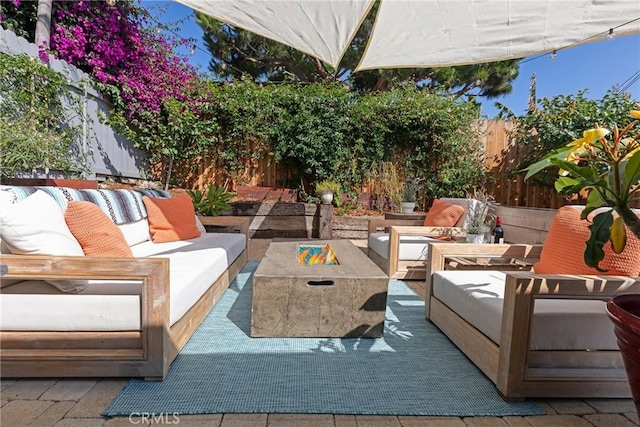 view of patio / terrace with an outdoor living space with a fire pit