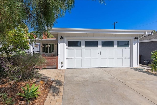 view of front of house featuring an attached garage, board and batten siding, and concrete driveway