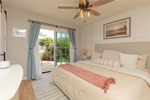 bedroom with access to exterior, light hardwood / wood-style flooring, and ceiling fan