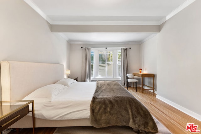 bedroom with crown molding and hardwood / wood-style flooring