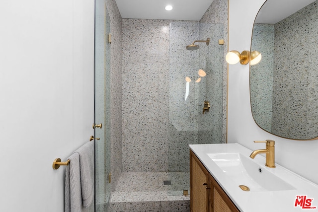 bathroom featuring vanity and a shower with shower door